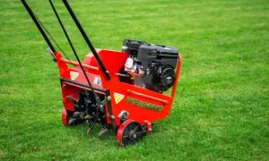 Czerwony aerator Weidemann z silnikiem Briggs & Stratton gotowy do pracy. Urządzenie zapewnia doskonałą wertykulację trawy, napowietrzając ją i usuwając filc.